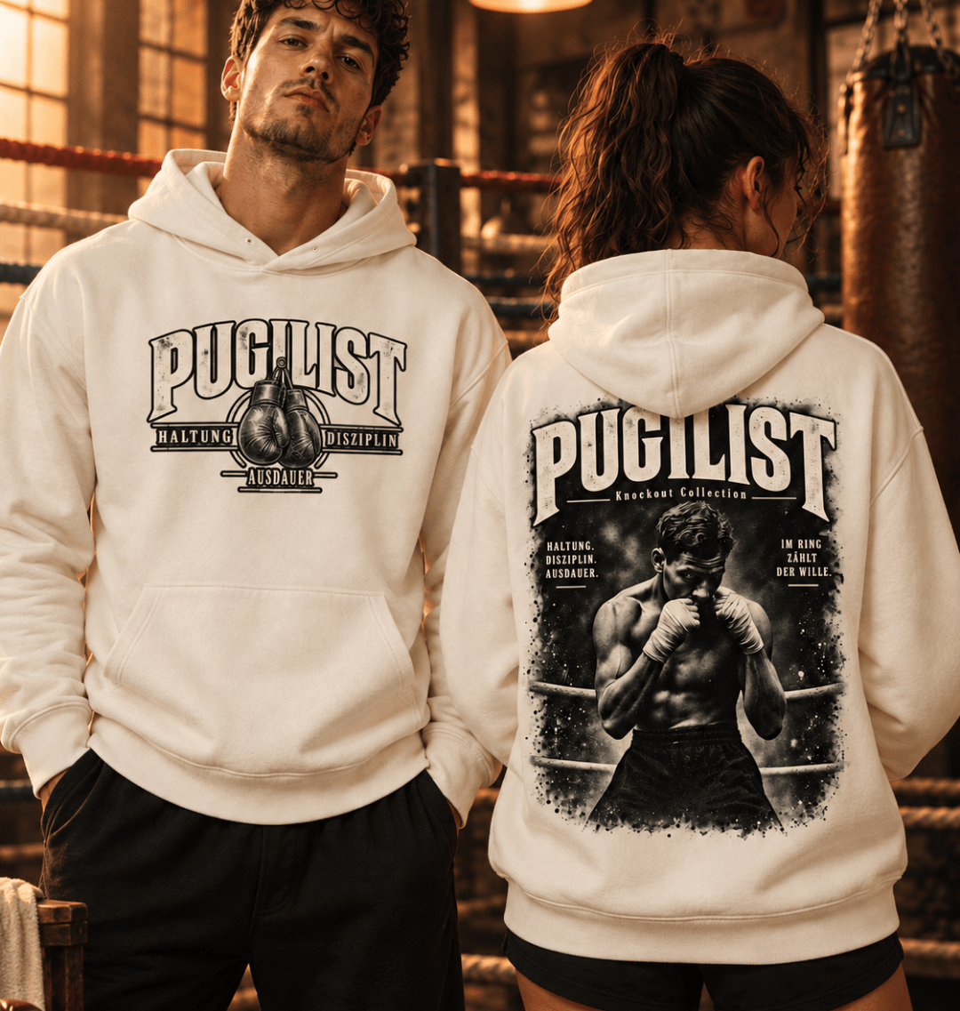 Mann und Frau tragen Natural Raw PUGILIST Ultra Heavy Hoodies mit Front- und Rückenprint in einer alten Boxhalle